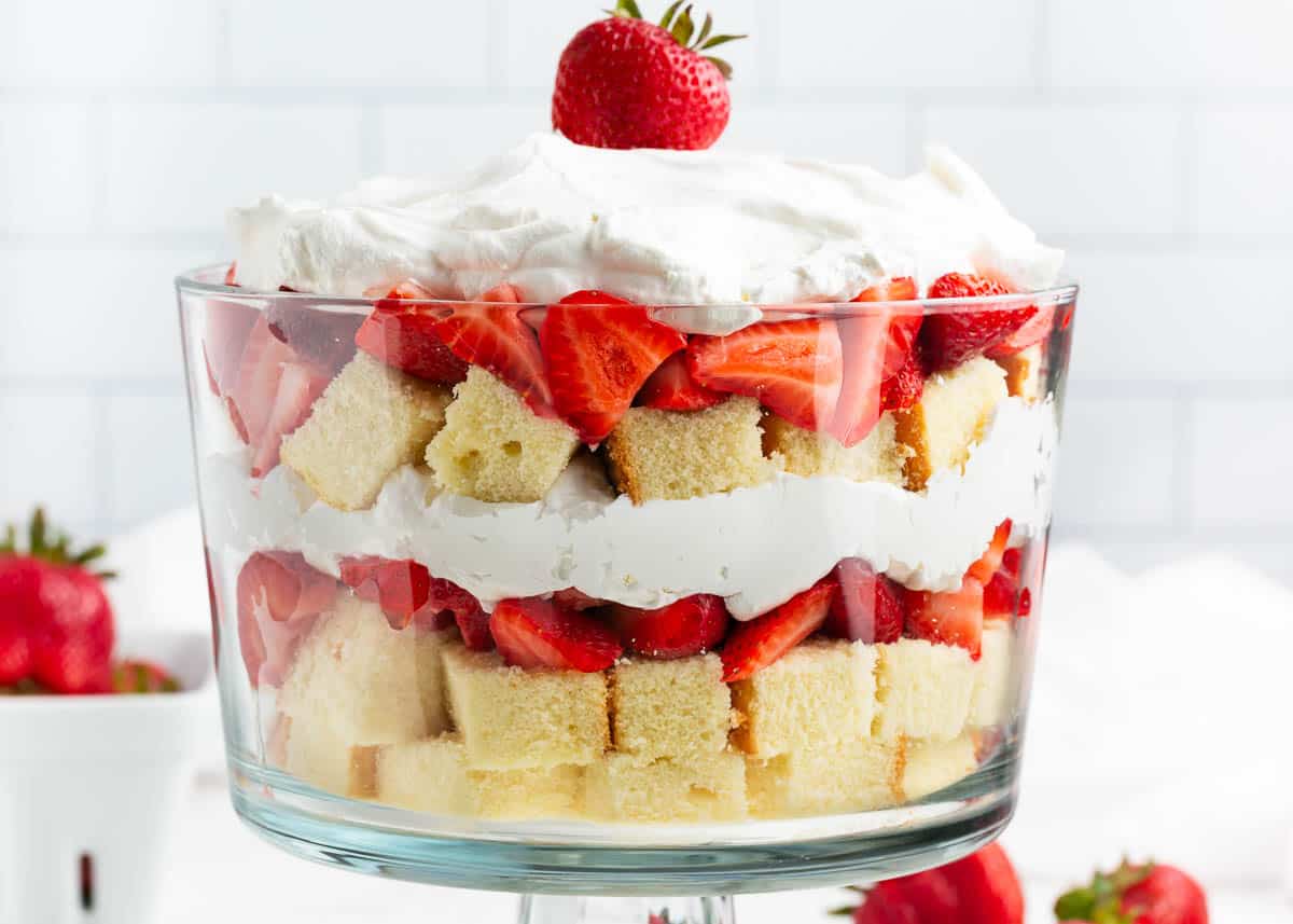 Strawberry shortcake trifle in a glass trifle dish.