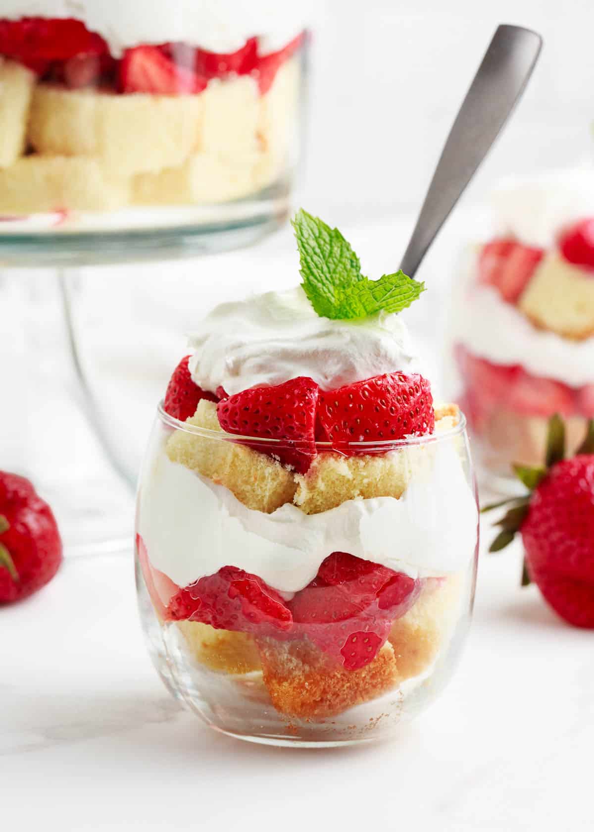 Strawberry shortcake trifle layered in a glass cup.