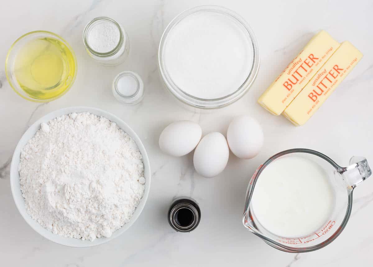 The best vanilla cake is an impressive yet simple one-bowl recipe that makes even a beginner baker feel like a professional! A soft tender cake infused with the heavenly flavor of vanilla that pairs well with any frosting! Vanilla cake ingredients on counter.