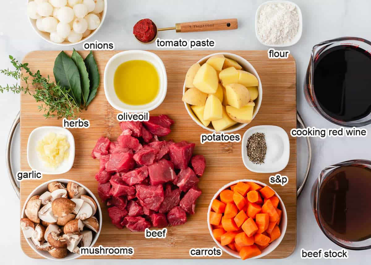 Beef Bourguignon ingredients on a wooden board.