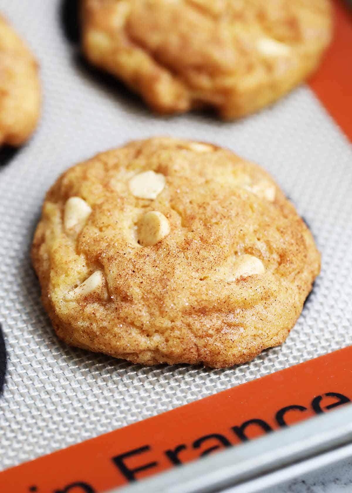 Pumpkin snickerdoodle cookie on baking sheet.