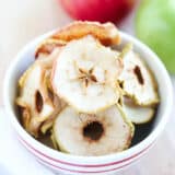 Apple chips in a red and white bowl.