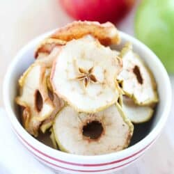 Apple chips in a red and white bowl.