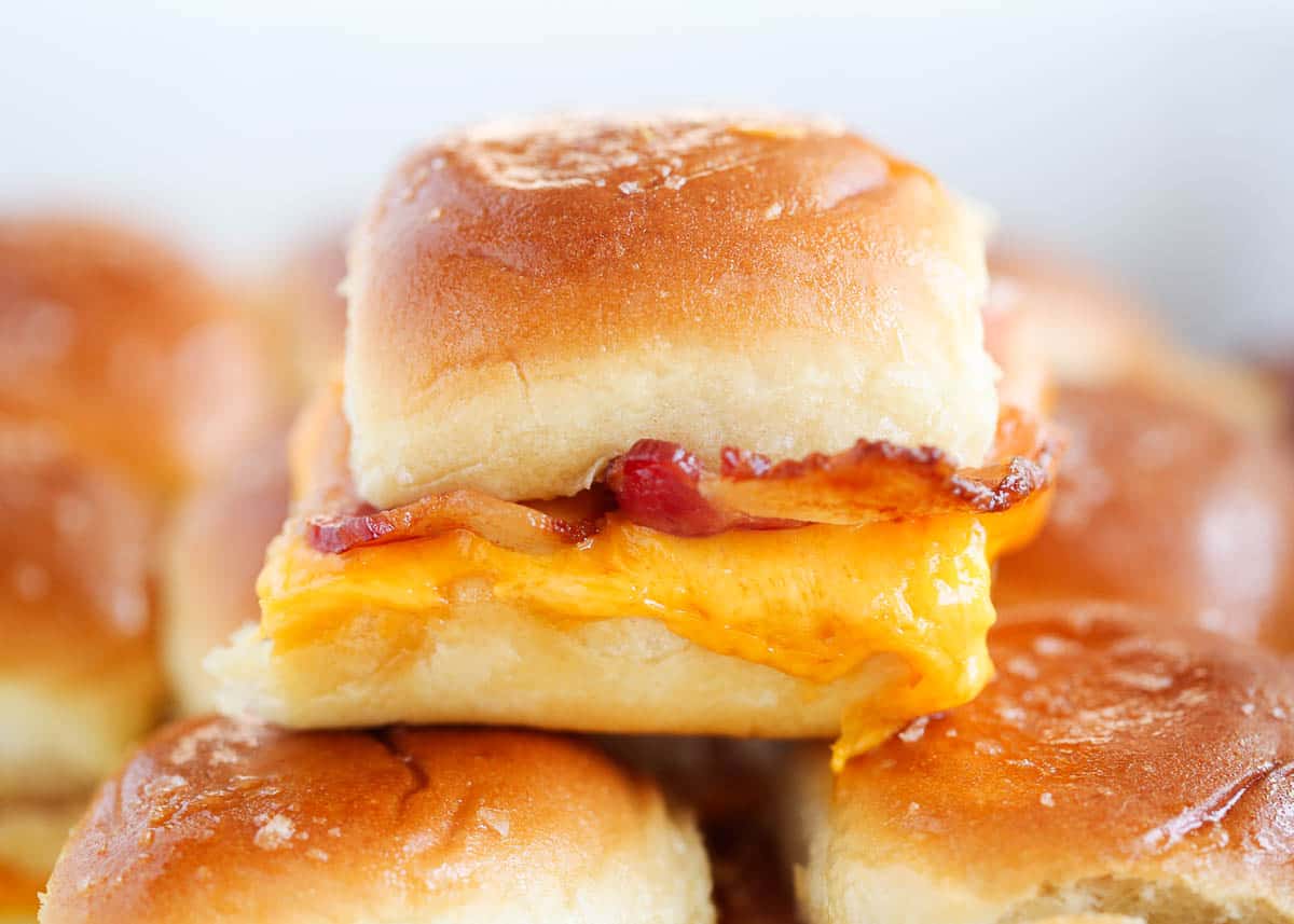 Breakfast sliders on top of sandwiches.