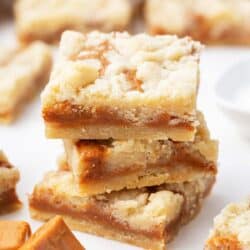 Stacked caramel butter bars on counter.