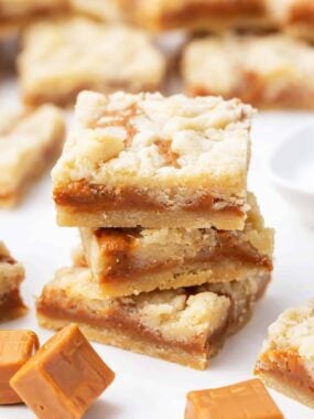 Stacked caramel butter bars on counter.