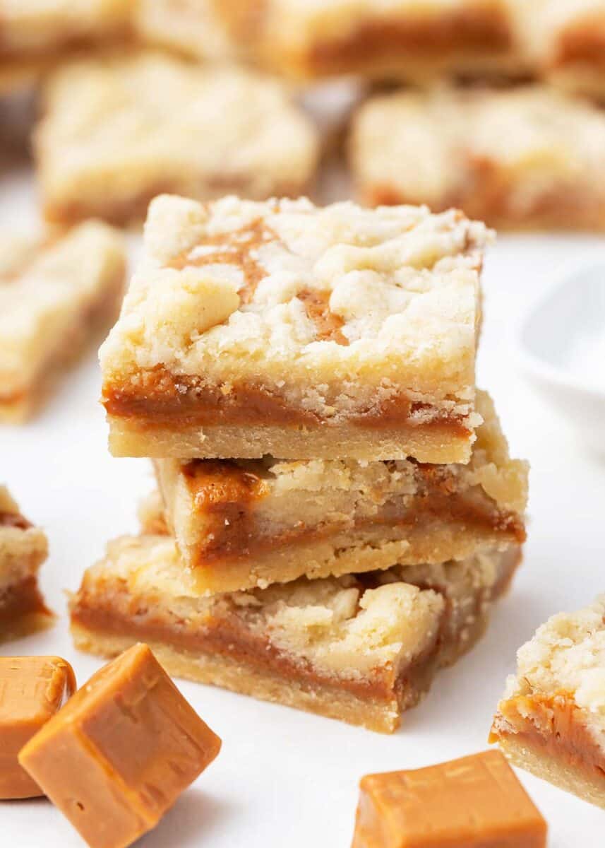 Stacked caramel butter bars on counter.