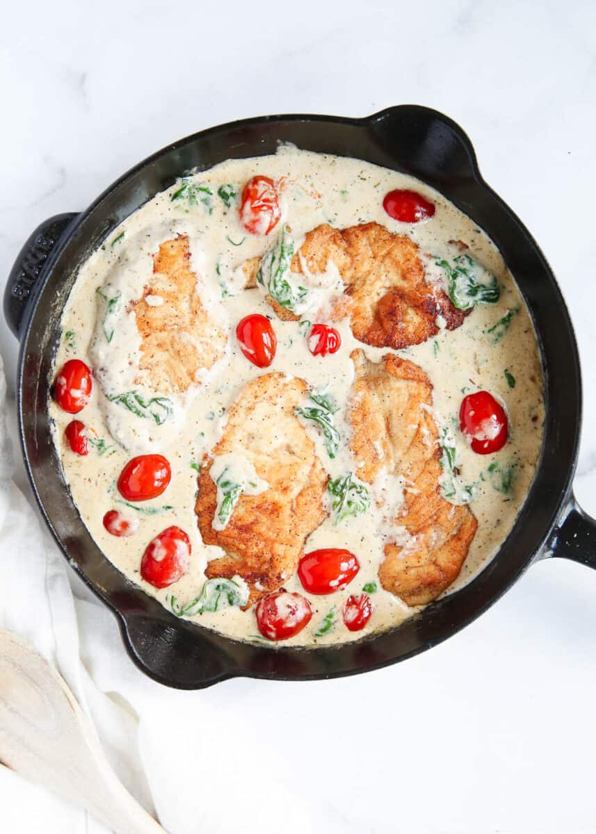 Chicken florentine in a cast iron skillet.