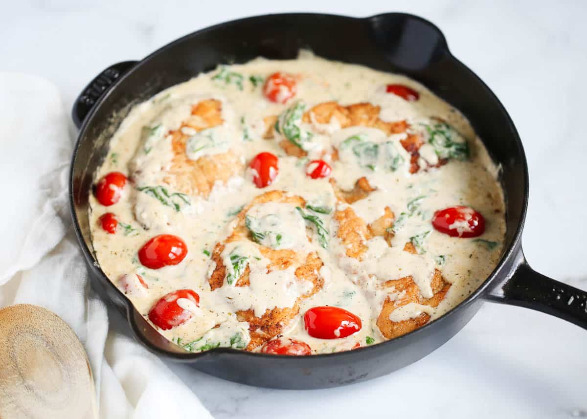 Chicken florentine cooked in a cast iron skillet.