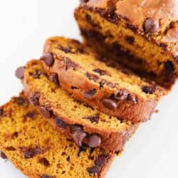 Sliced chocolate chip pumpkin bread on parchment paper.