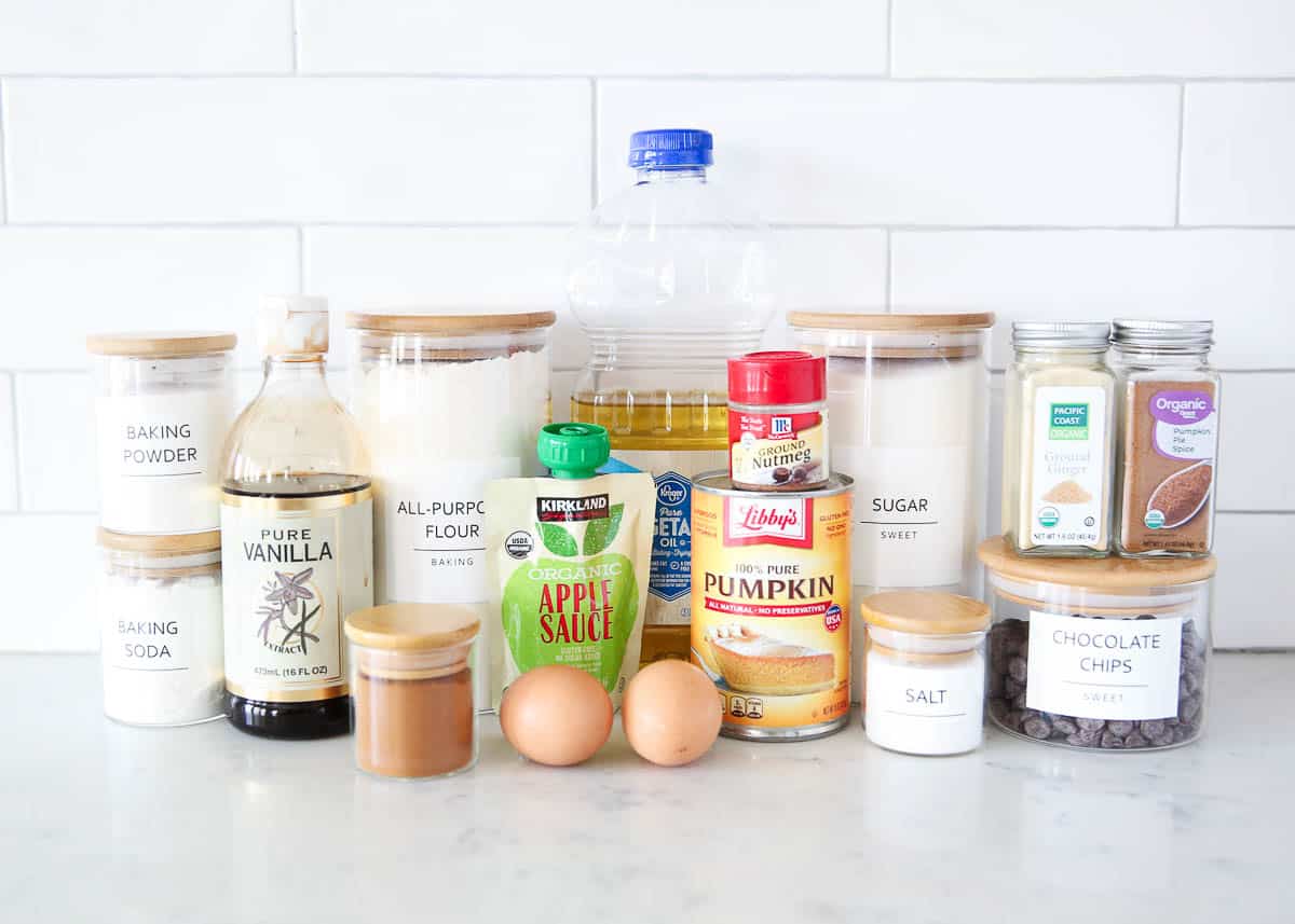 Chocolate chip pumpkin bread ingredients on marble counter.