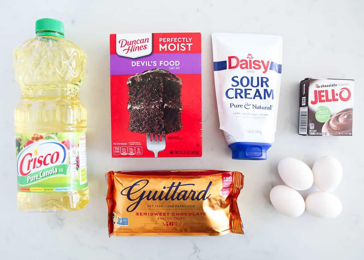 This is simply the BEST chocolate cupcake recipe that you can make from a cake mix. They are super soft, rich and topped with a lush buttercream frosting. You won't believe how easy these are to make! Chocolate cupcake ingredients on counter.