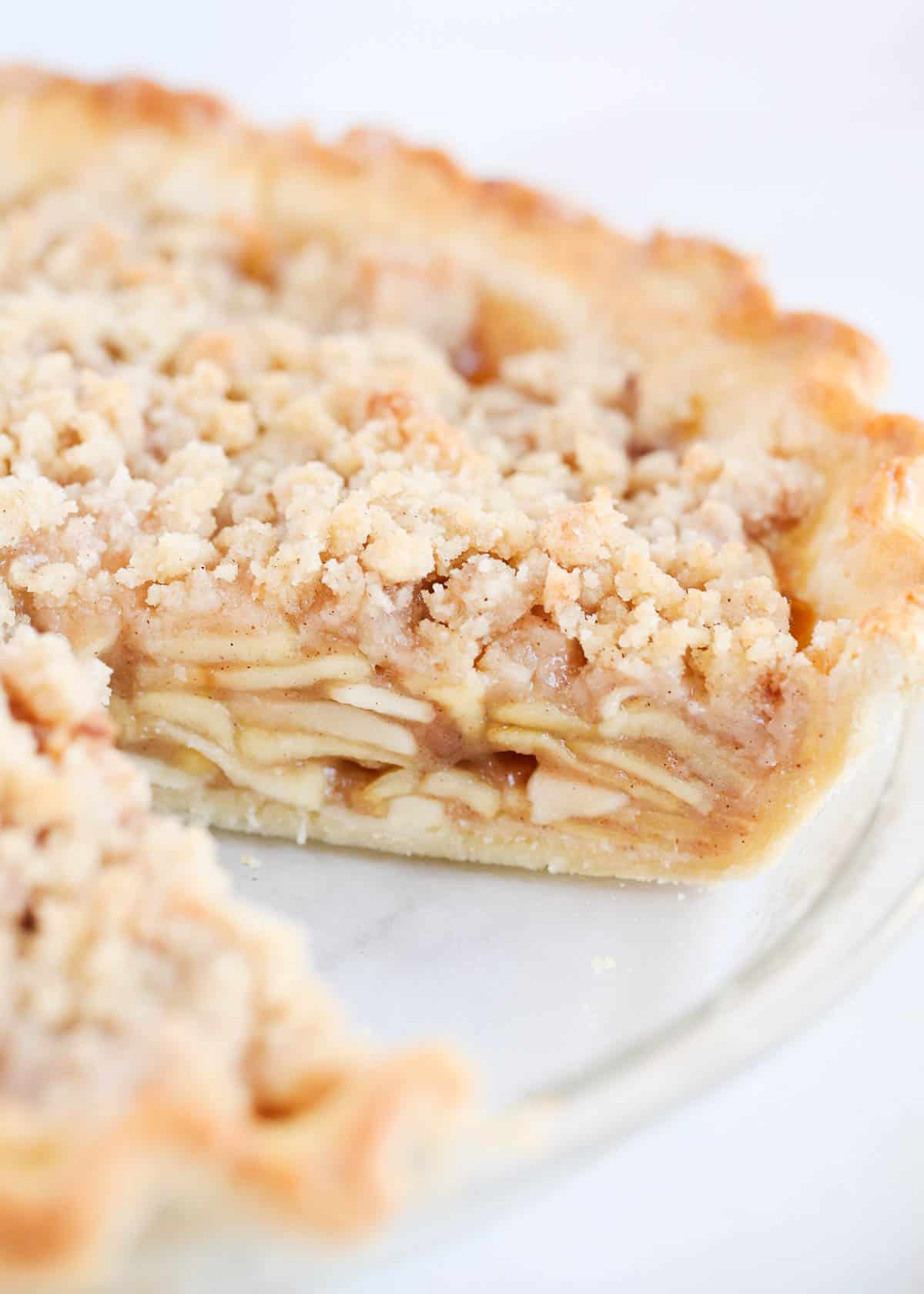 Sliced dutch apple pie in a glass baking dish.