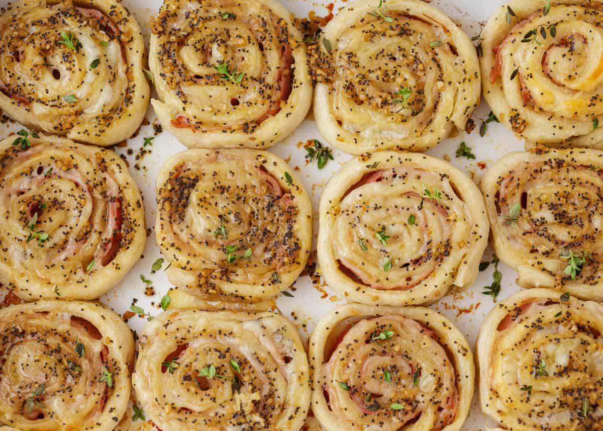 Ham and cheese pinwheels in a baking dish.