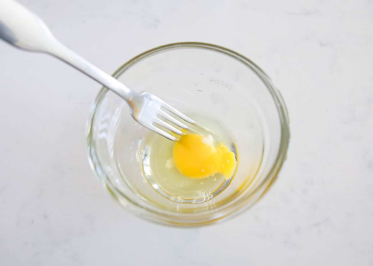 Egg and fork in a glass bowl.