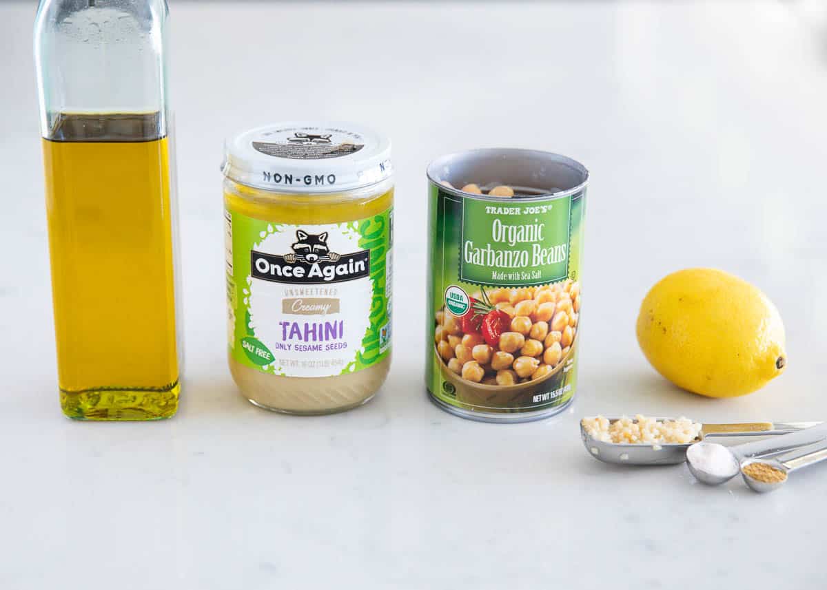 Hummus ingredients on a marble countertop.