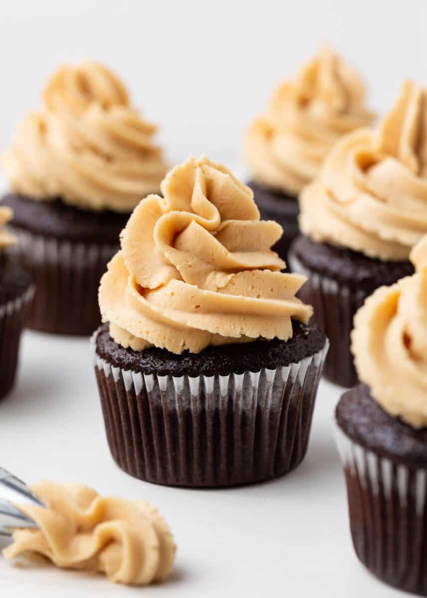 Peanut butter frosting on top of chocolate cupcakes.