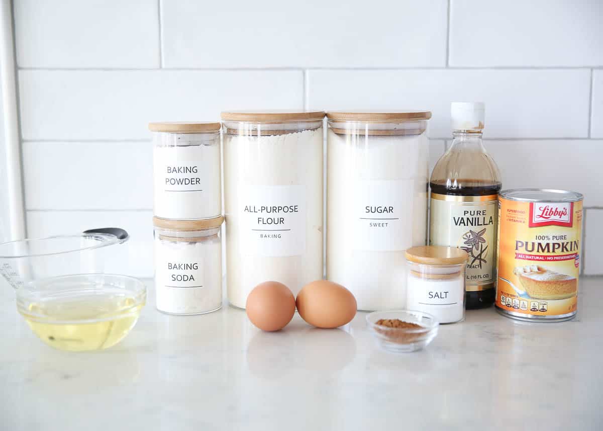 Pumpkin bread ingredients on marble countertop.