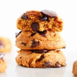 Stacked pumpkin cake mix cookies with chocolate.