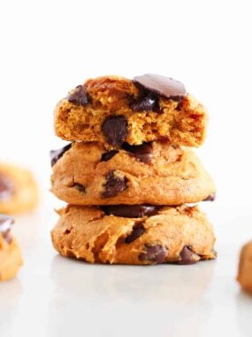 Three pumpkin cookies with cake mix stacked on the counter.