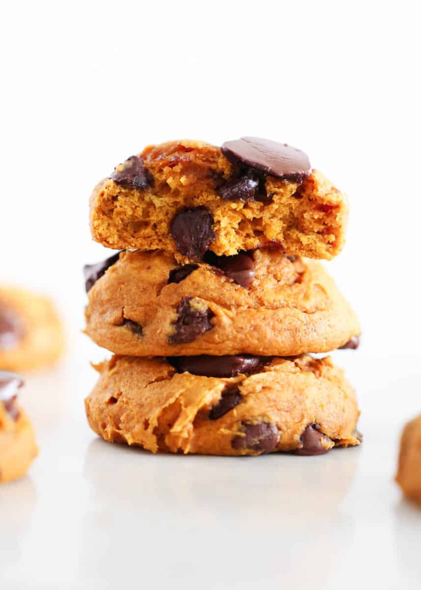 Stacked pumpkin cake mix cookies with chocolate.