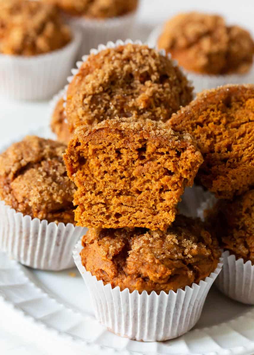 Sliced pumpkin muffins made with a cake mix on a white plate.
