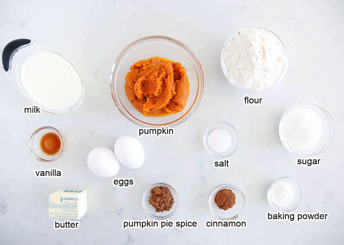 Pumpkin waffle ingredients on a marble countertop.