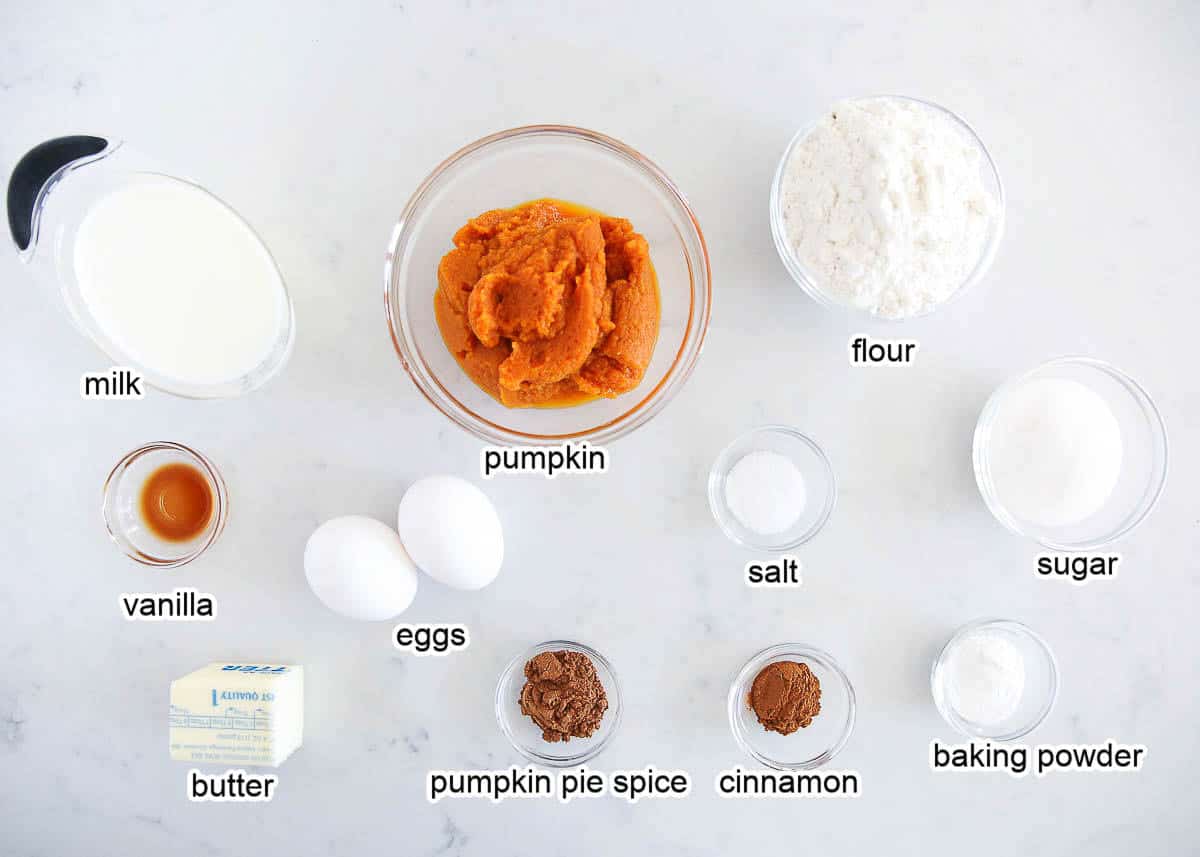 Pumpkin waffle ingredients on a marble countertop.