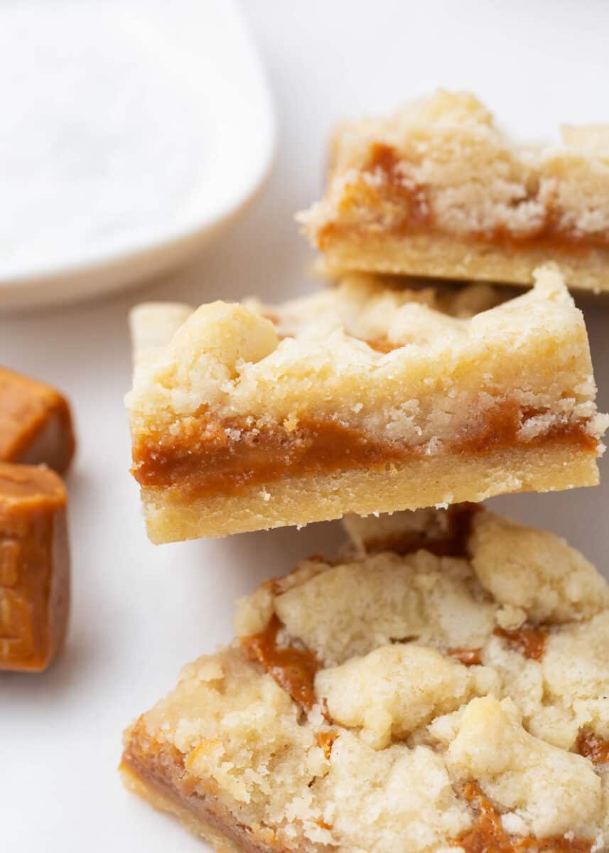 Slice of caramel butter bar on white plate.