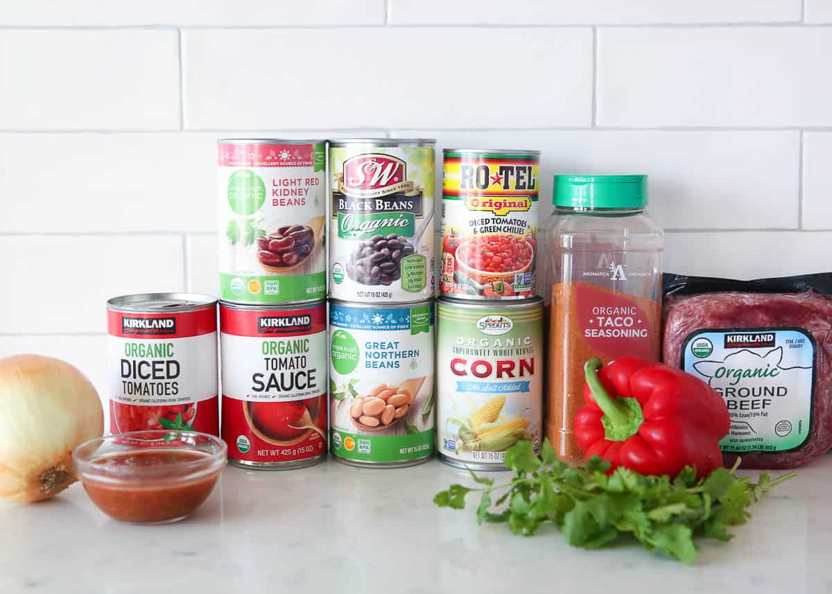 Taco soup ingredients on a marble countertop.