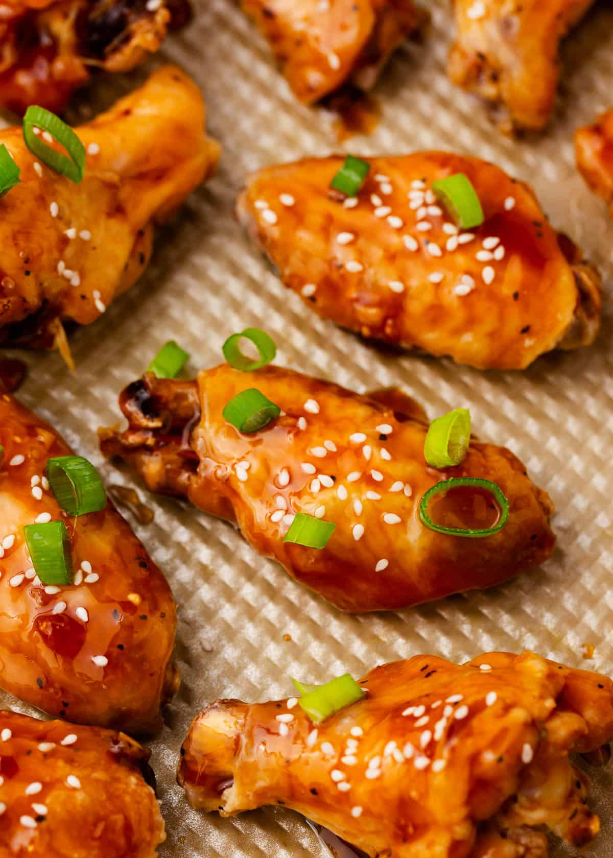 Baked teriyaki chicken wings on a baking sheet.