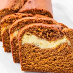 Sliced pumpkin bread with cream cheese.