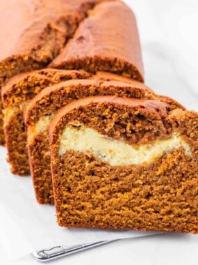 Sliced pumpkin bread with cream cheese.