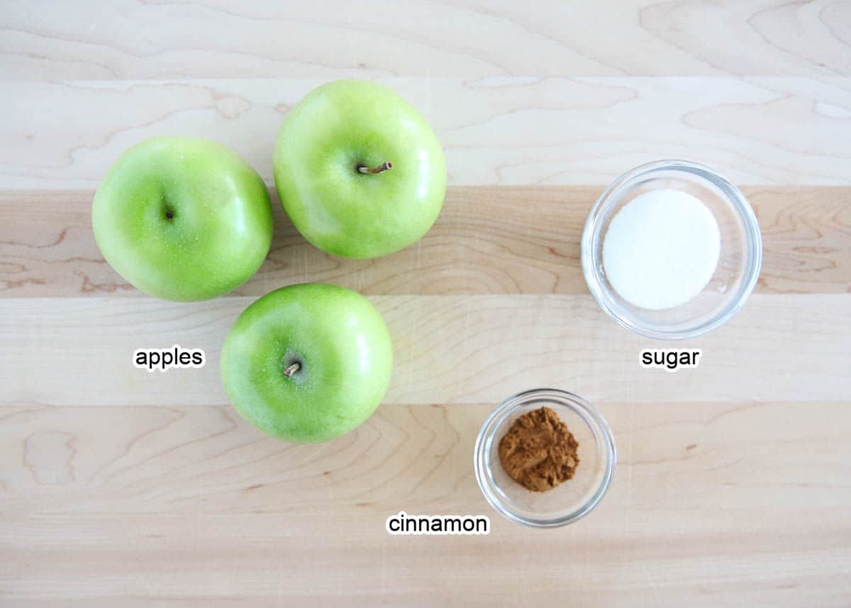 Apple chip ingredients on wooden board.