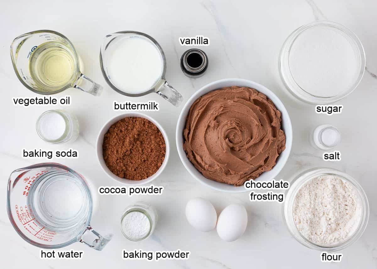 Chocolate cupcake ingredients on marble countertop.