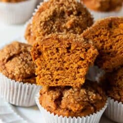 Sliced pumpkin muffins made with a cake mix on a white plate.