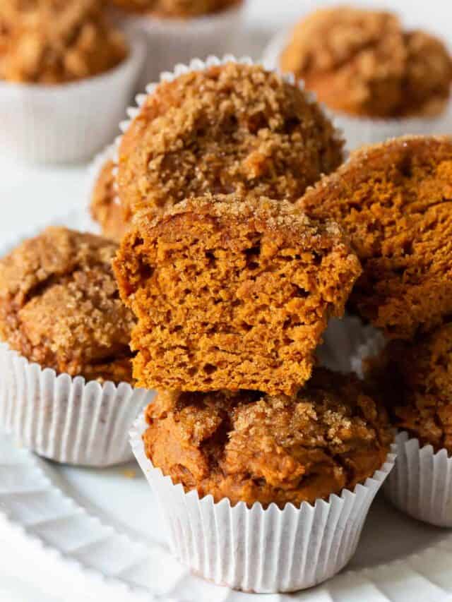 Sliced pumpkin muffins made with a cake mix on a white plate.