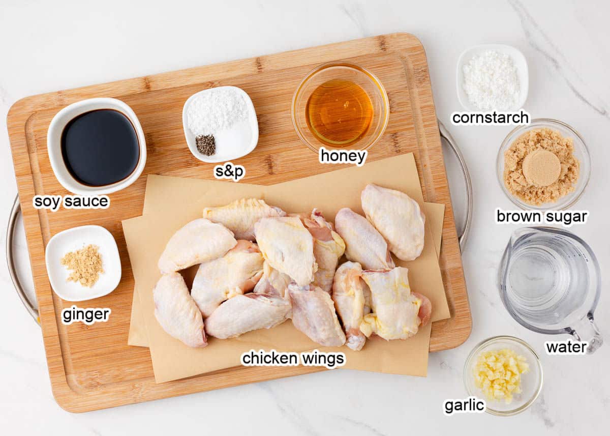 Teriyaki chicken wing ingredients on wooden board.