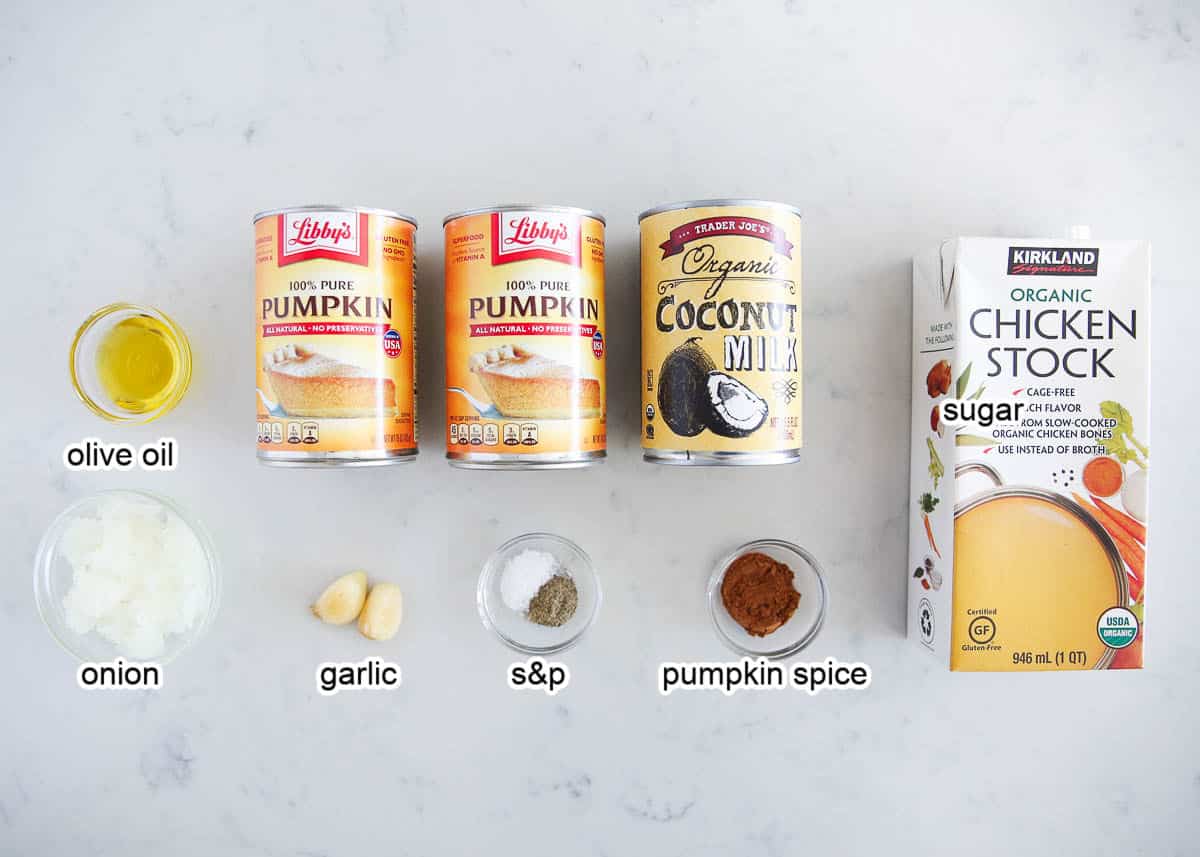 Pumpkin soup ingredients on a marble countertop.