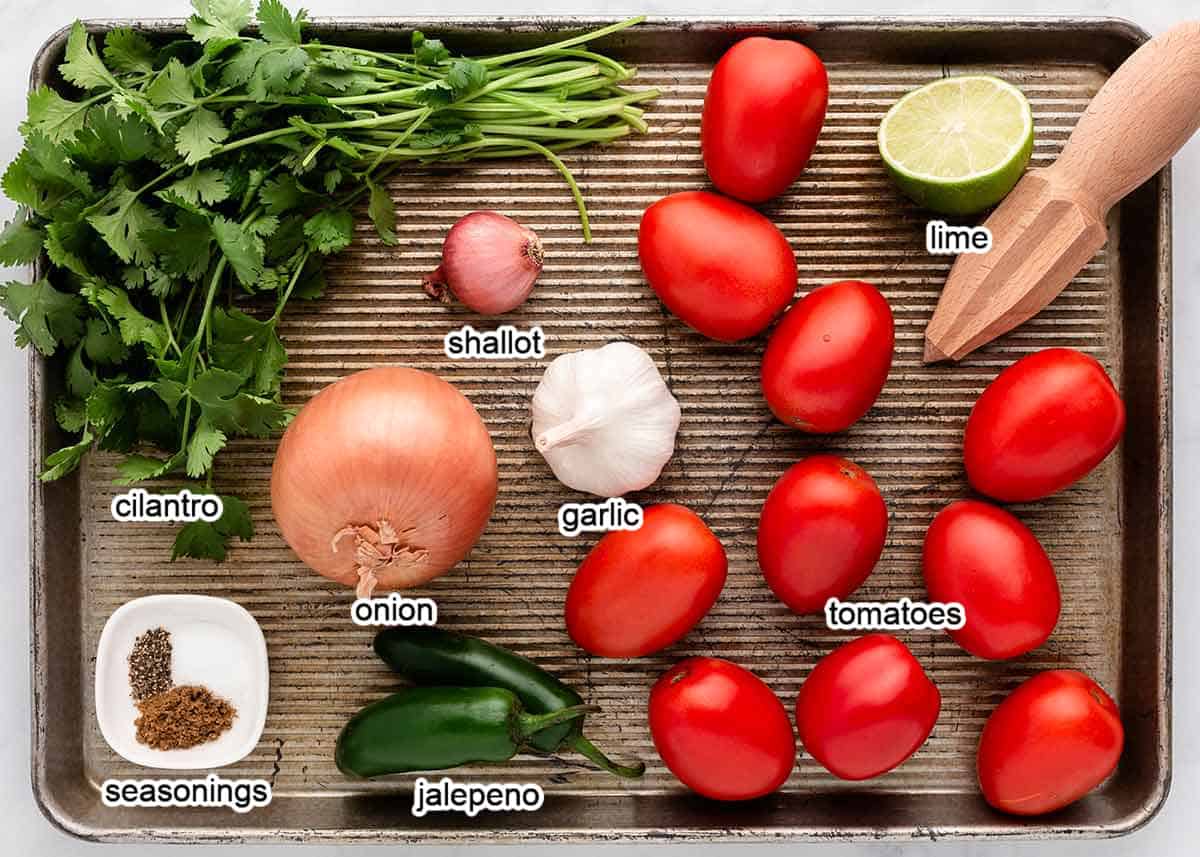 Roasted salsa ingredients on a baking sheet.