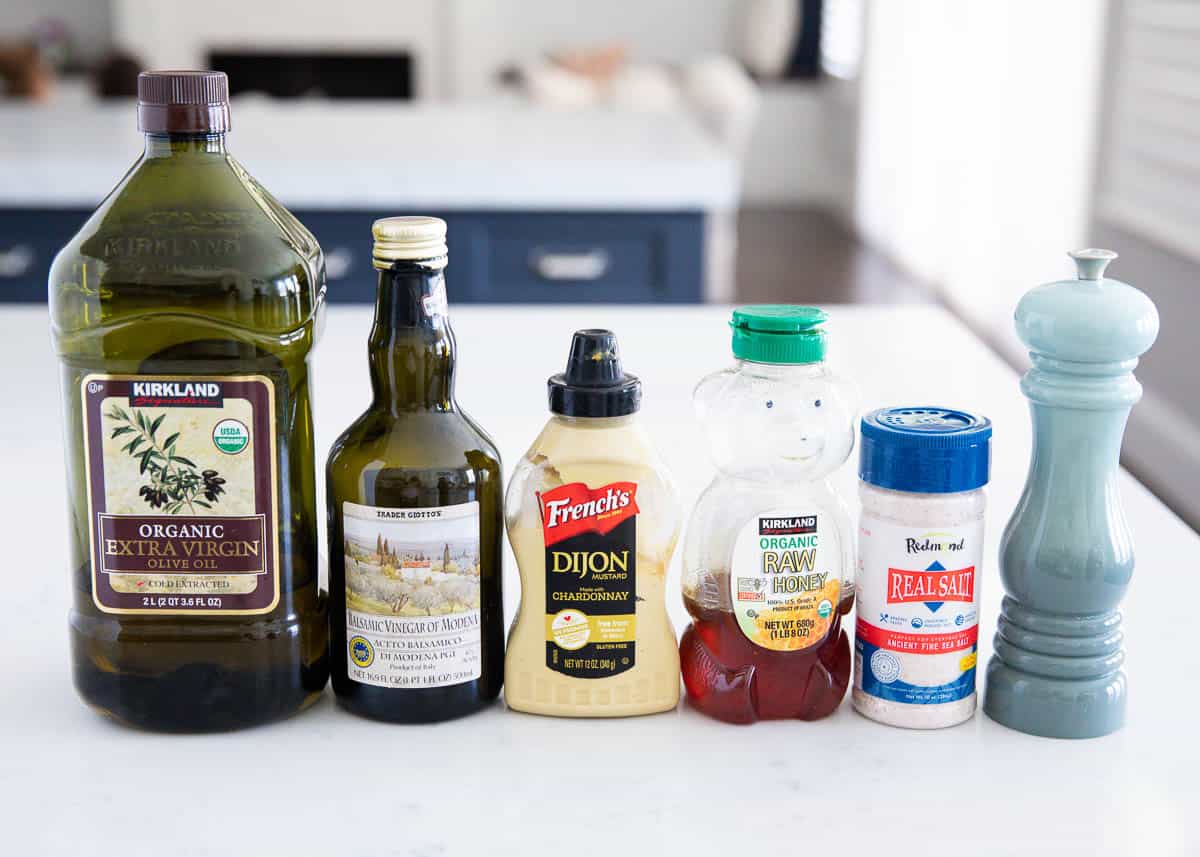 Homemade balsamic dressing ingredients on counter.