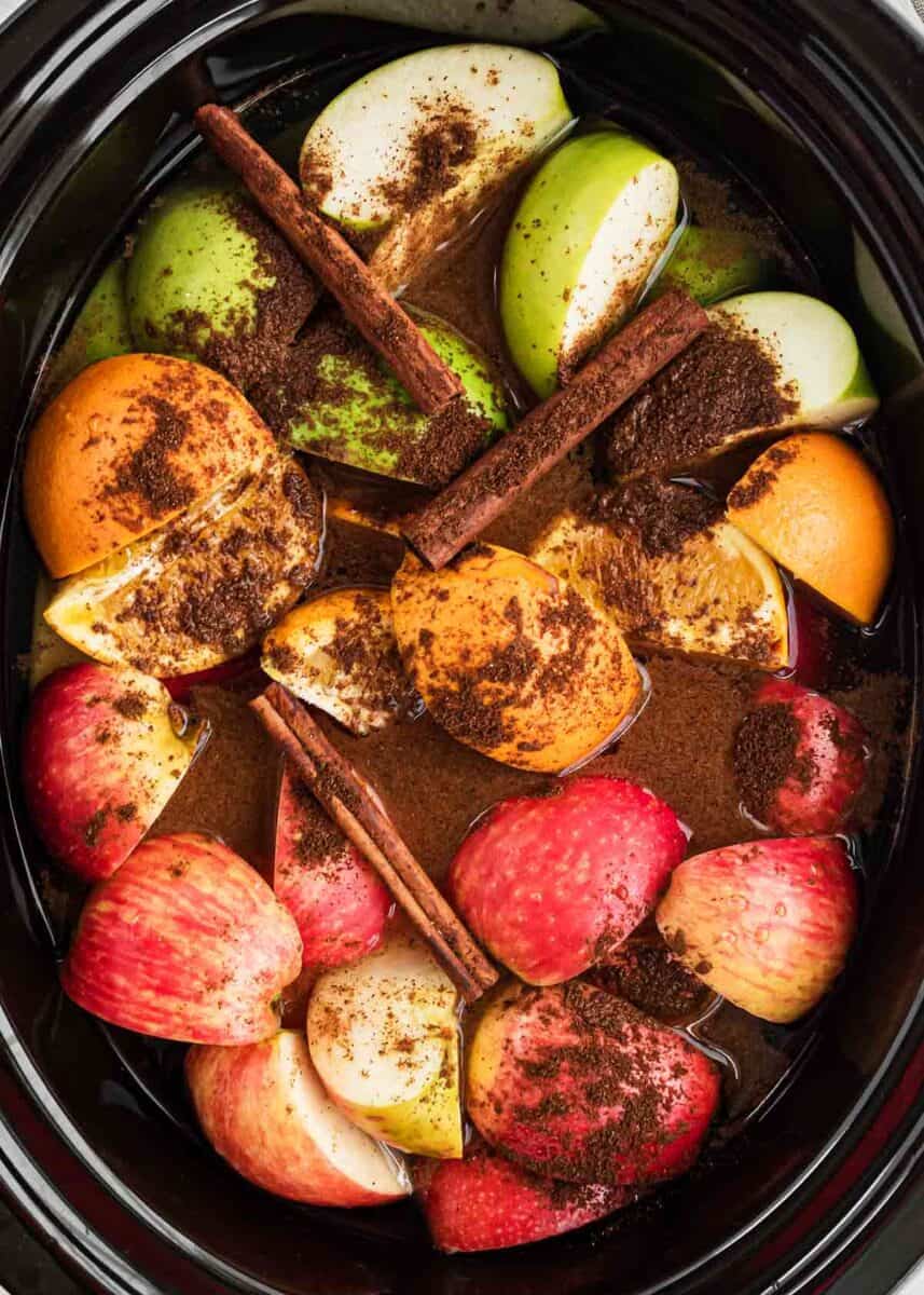 Apple cider ingredients cooking in crockpot.