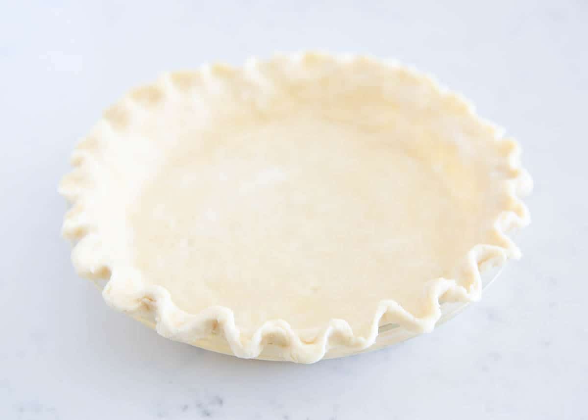 Pie crust ready to bake in pie dish.