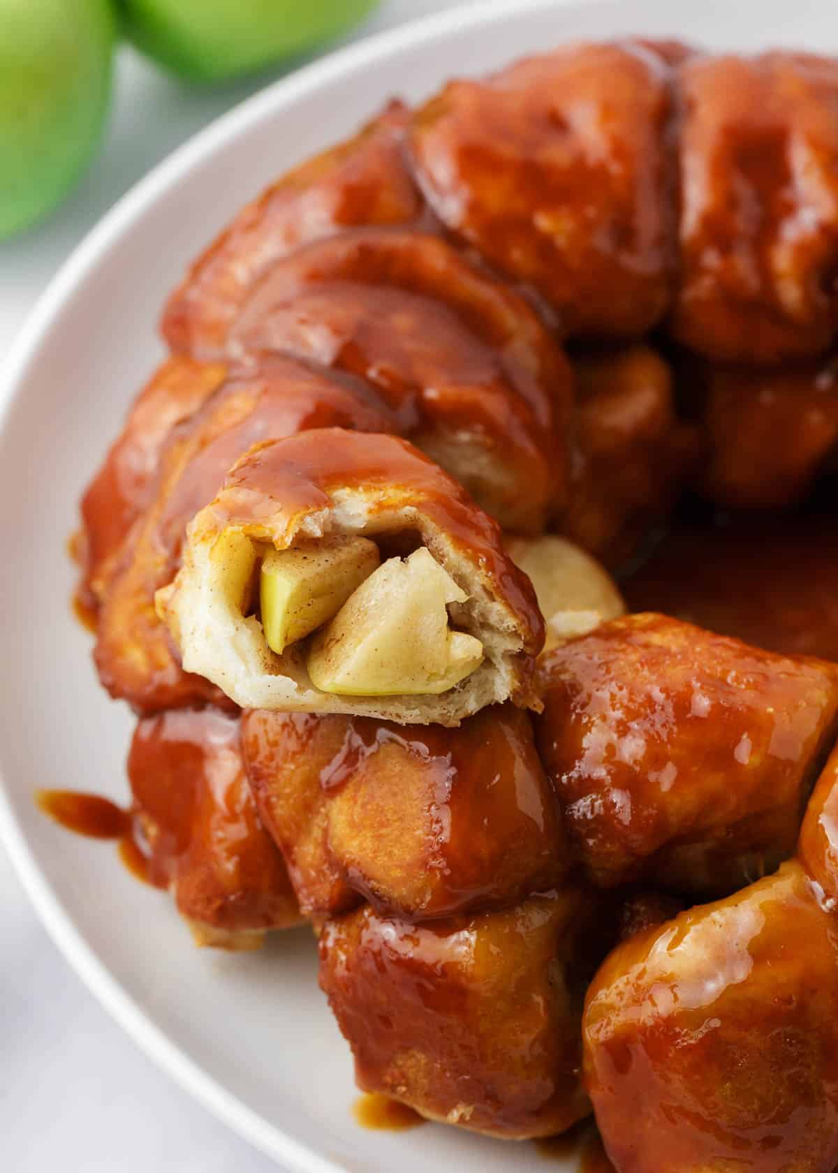 Apple monkey bread piece on a white plate.