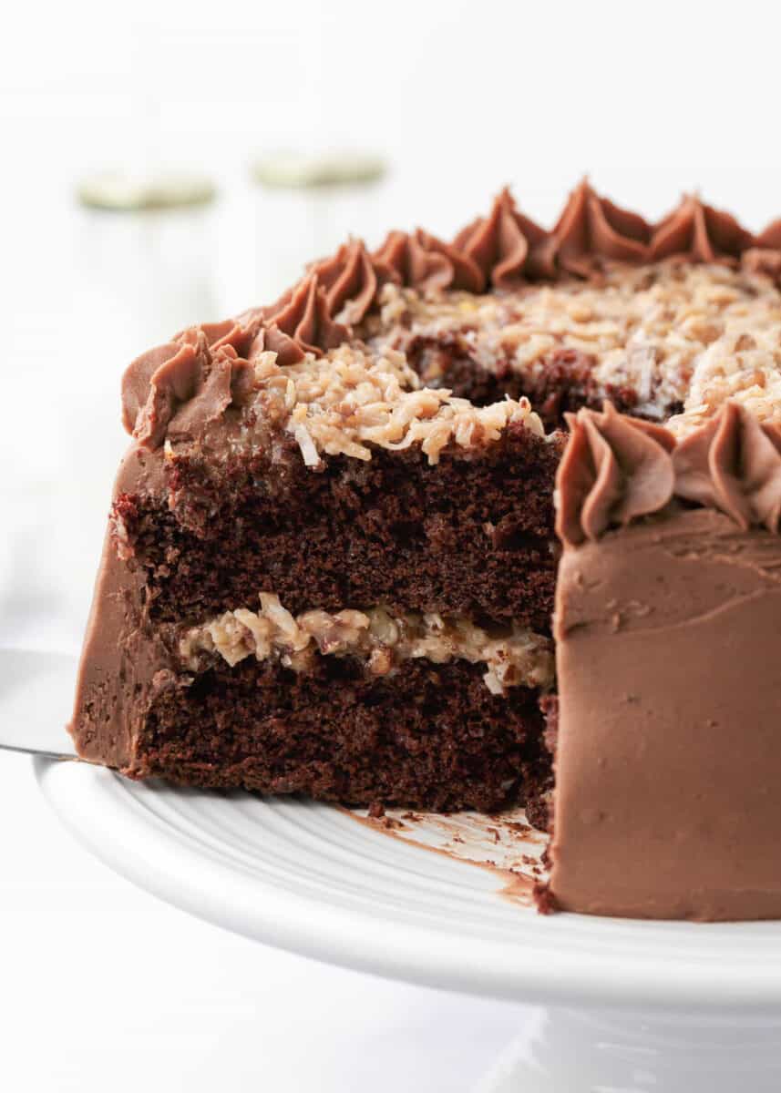 Slice of German chocolate cake on cake stand.