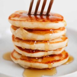 Stack of mini Silver Dollar Pancakes with syrup.