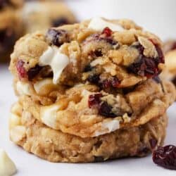 Stack of oatmeal cranberry cookies on a white plate.