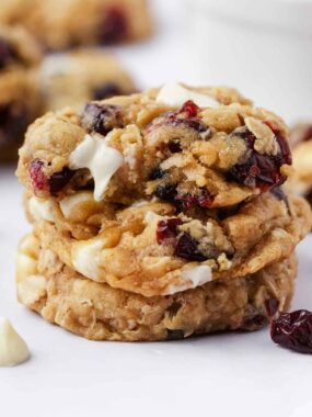 Stack of oatmeal cranberry cookies on a white plate.