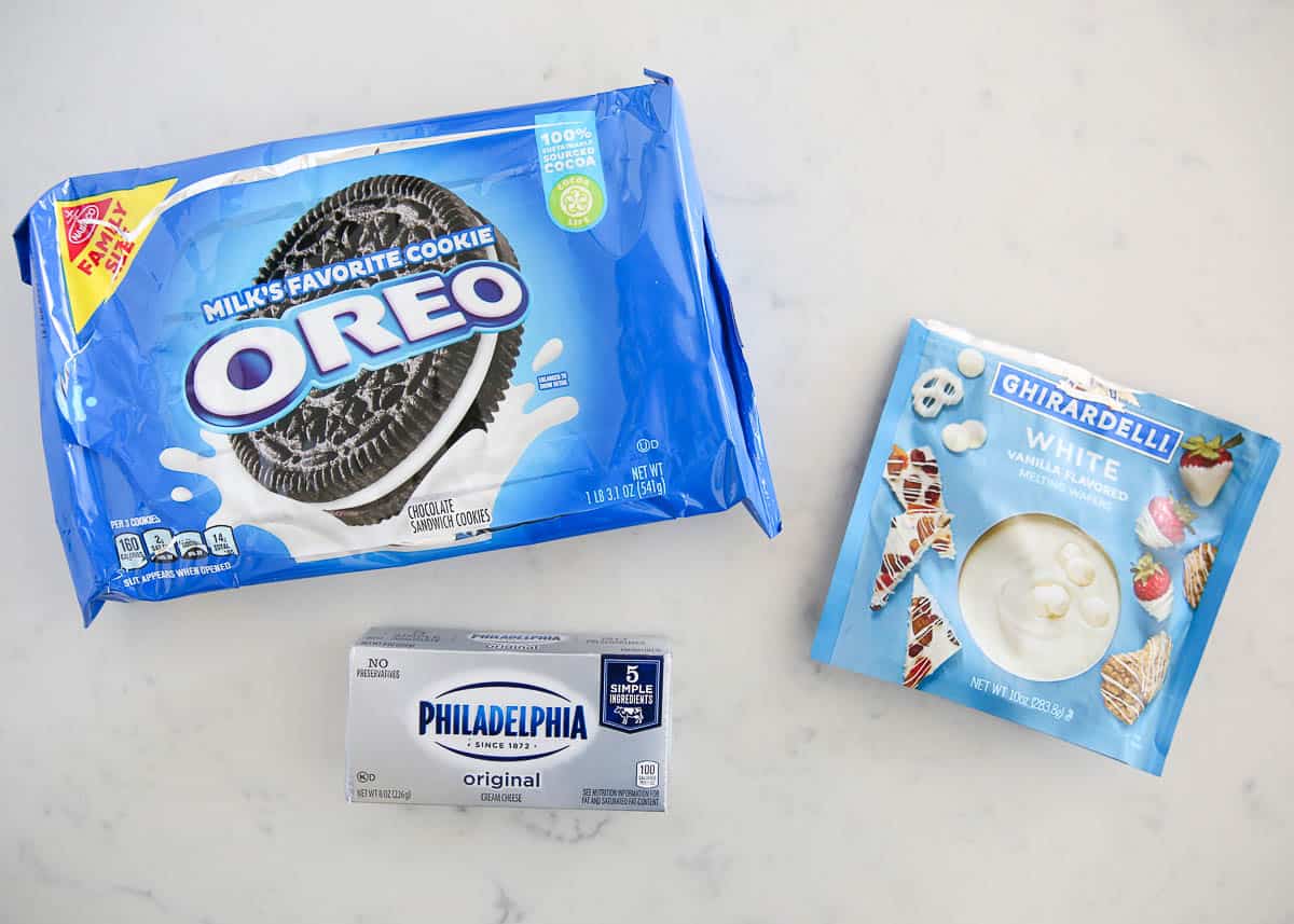 Oreo ball ingredients on marble counter.