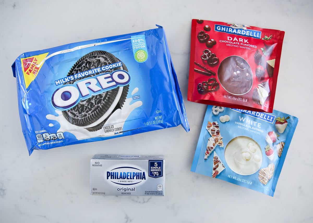 Oreo ball ingredients on a marble counter.